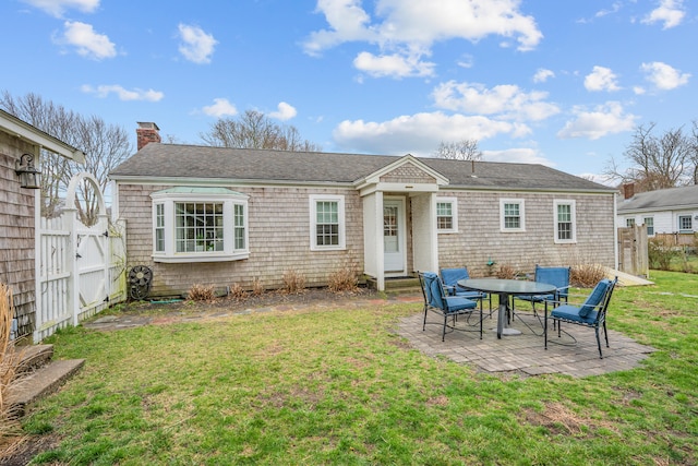 193 Main St, Sandwich, MA 02563 - back of property featuring fence, a yard, a patio, and a chimney