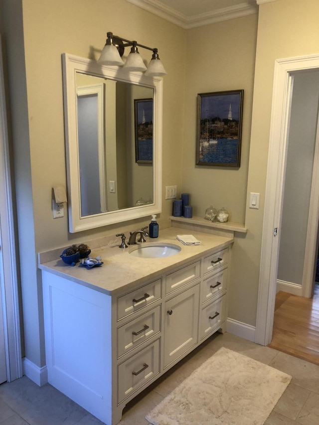 bathroom featuring crown molding, tile patterned flooring, and vanity