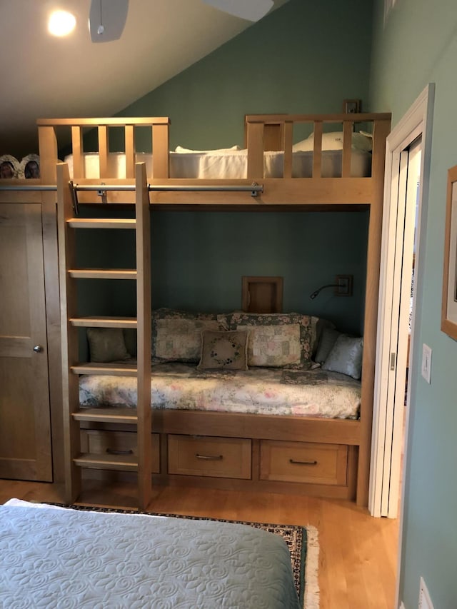 bedroom featuring vaulted ceiling and light hardwood / wood-style floors