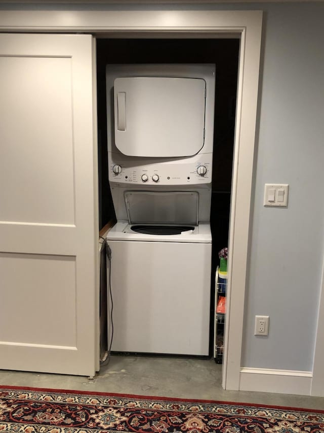 washroom with stacked washer / drying machine