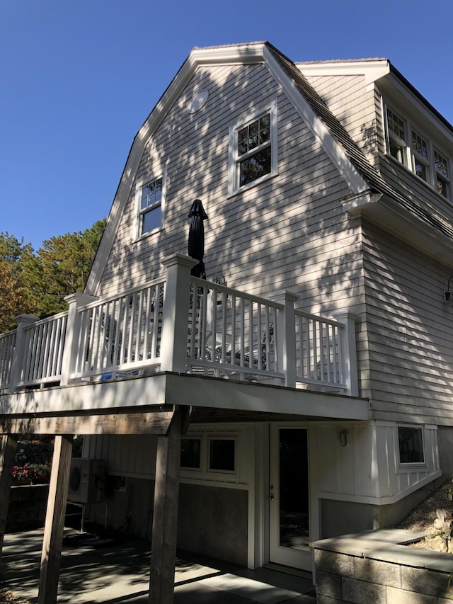 rear view of house with a wooden deck