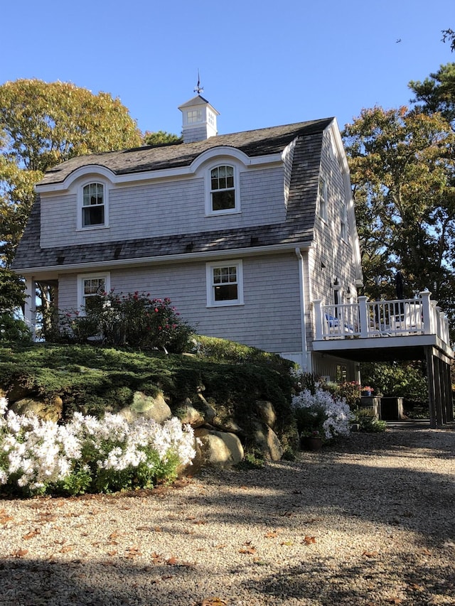 back of house with a deck