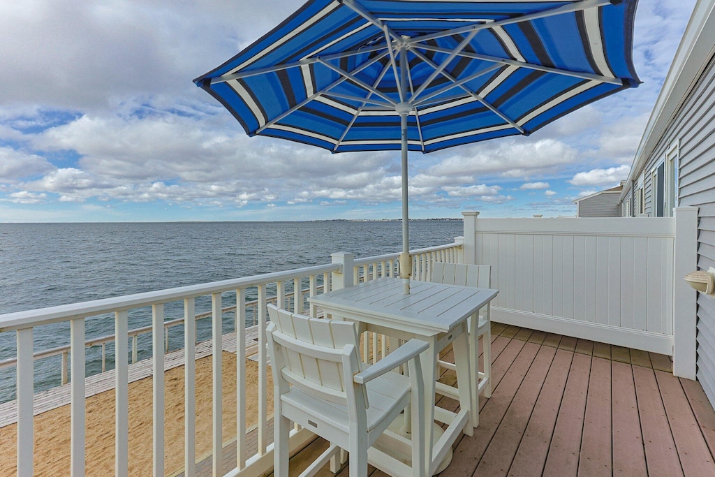 wooden terrace featuring a water view