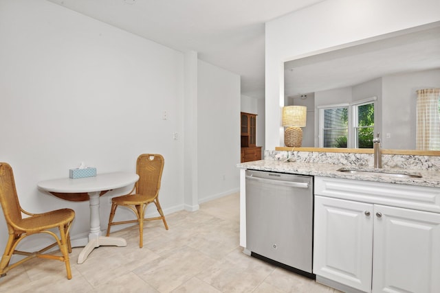 12 Wildflower Vlg, Yarmouth Port, MA 02675 - kitchen with dishwasher, a sink, white cabinets, light stone counters, and baseboards