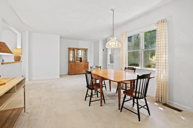 12 Wildflower Vlg, Yarmouth Port, MA 02675 - dining room featuring a chandelier, baseboards, and light carpet