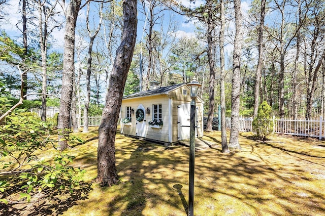 view of shed featuring fence