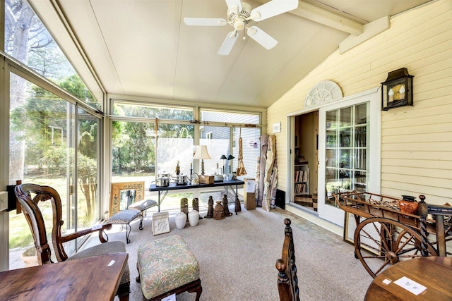 sunroom / solarium featuring a ceiling fan and beam ceiling