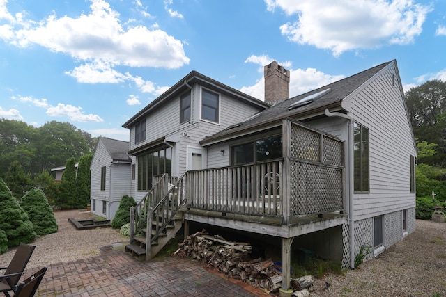 51 Manitoba Rd, Mashpee, MA 02649 - back of house featuring a chimney, a patio, a wooden deck, and roof with shingles