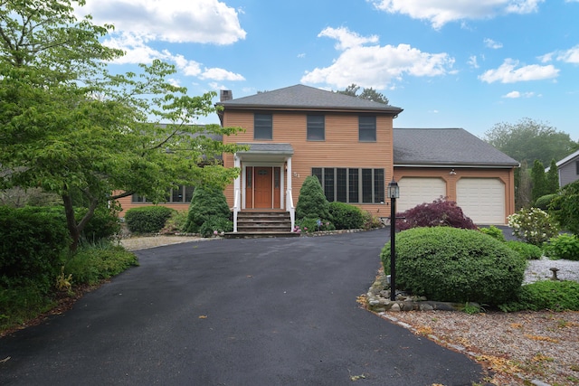 51 Manitoba Rd, Mashpee, MA 02649 - view of front facade with driveway, an attached garage, and a chimney
