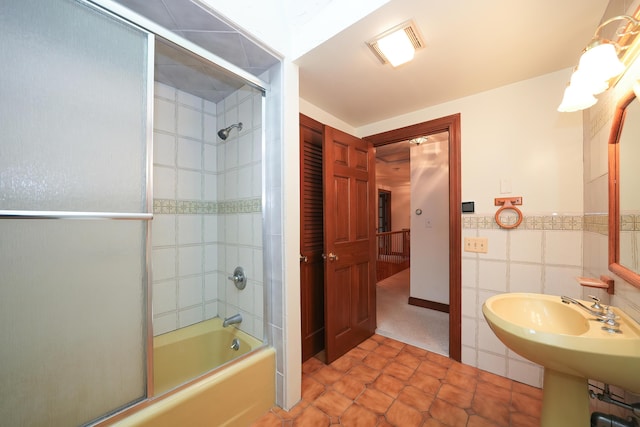 51 Manitoba Rd, Mashpee, MA 02649 - full bathroom featuring bath / shower combo with glass door, tile walls, tile patterned flooring, and wainscoting