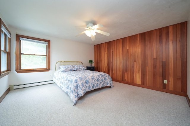 51 Manitoba Rd, Mashpee, MA 02649 - bedroom featuring baseboard heating, wood walls, carpet floors, and a ceiling fan