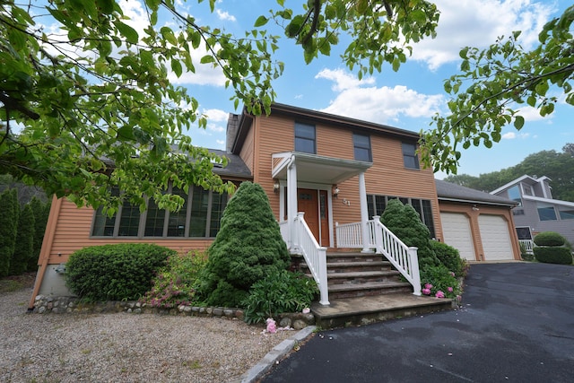 51 Manitoba Rd, Mashpee, MA 02649 - view of front facade featuring an attached garage and asphalt driveway