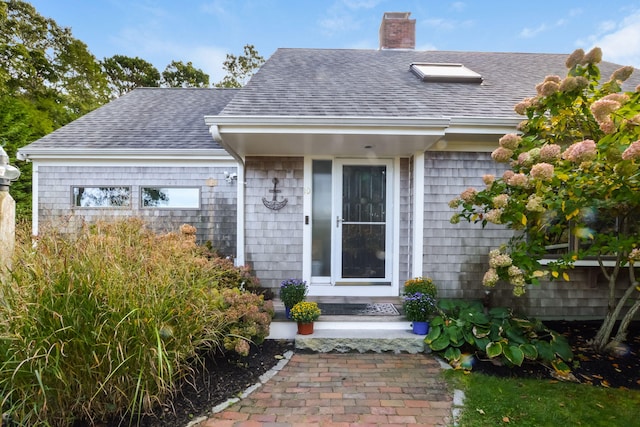 10 Westerly Dr, Bourne, MA 02532 - property entrance with a shingled roof and a chimney