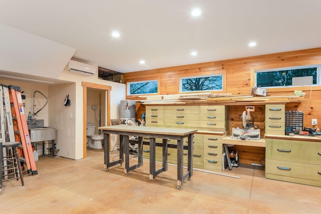 10 Westerly Dr, Bourne, MA 02532 - interior space featuring recessed lighting, an AC wall unit, a workshop area, and concrete floors