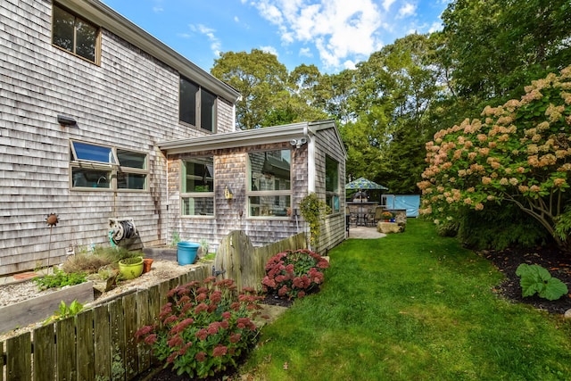 10 Westerly Dr, Bourne, MA 02532 - view of property exterior featuring fence and a yard
