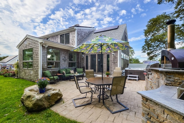 10 Westerly Dr, Bourne, MA 02532 - back of property featuring area for grilling, a yard, solar panels, a patio area, and an outdoor living space