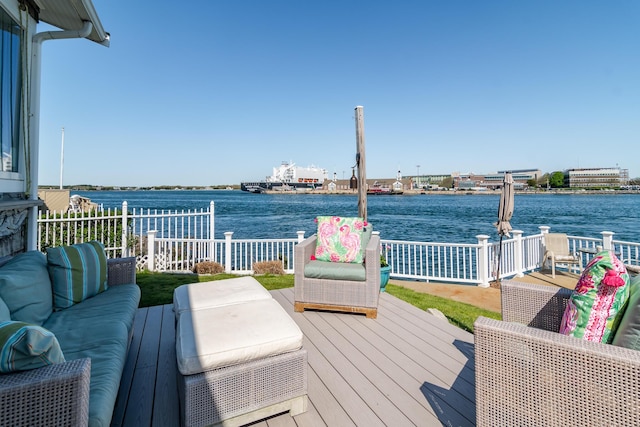 wooden terrace featuring a water view and an outdoor living space