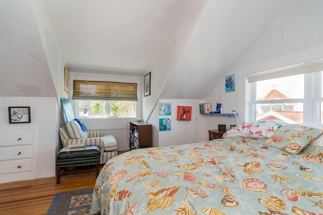 bedroom featuring wood finished floors and vaulted ceiling