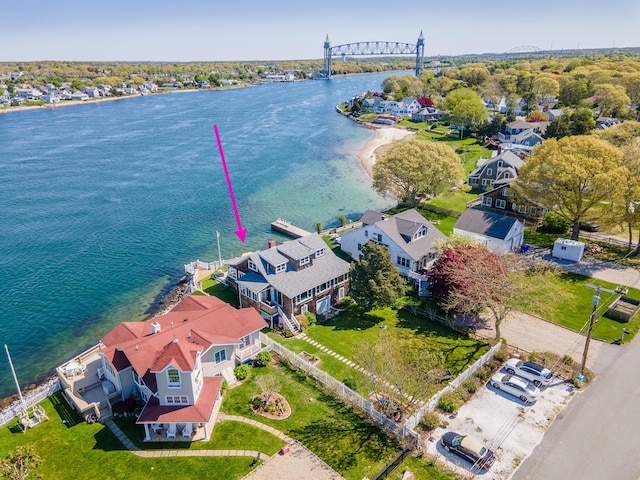 aerial perspective of suburban area with a large body of water and a notable bridge