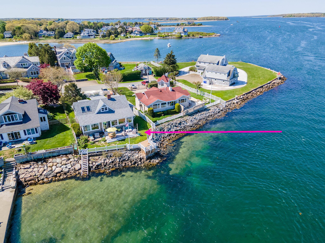 aerial perspective of suburban area with a large body of water