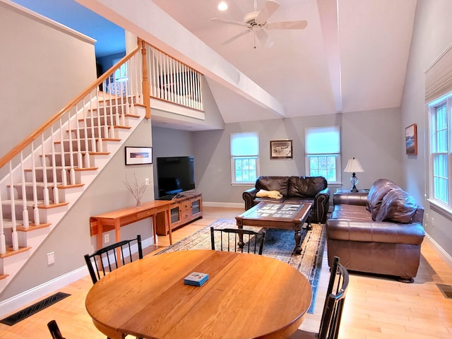 dining room with vaulted ceiling, ceiling fan, and light wood-type flooring