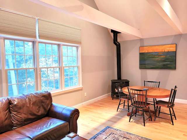 dining space with a wood stove and light wood-type flooring