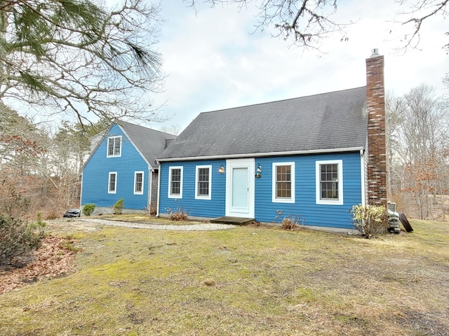 new england style home featuring a front yard