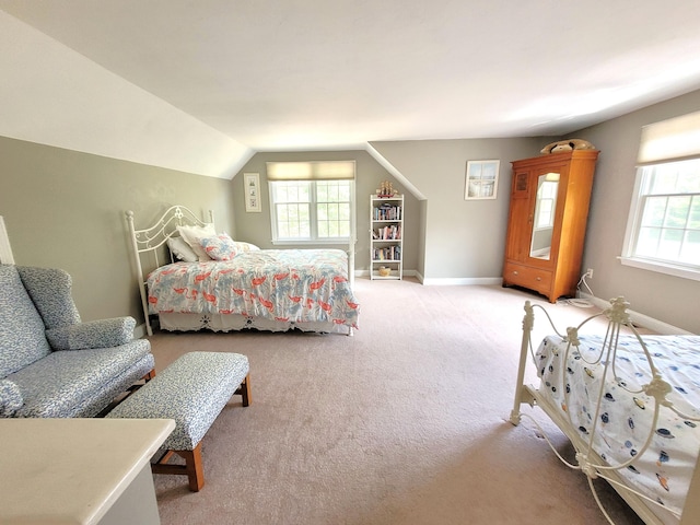 bedroom with lofted ceiling, light carpet, and multiple windows