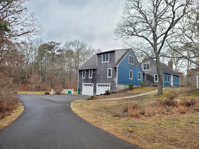 view of side of home featuring a garage and a yard