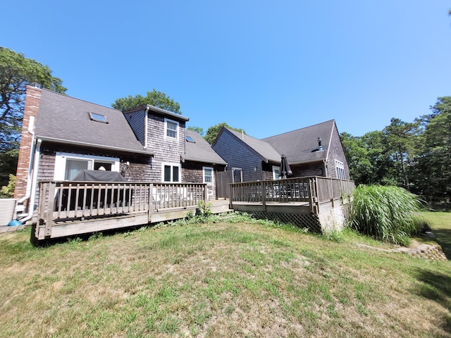393 Thousand Oaks Dr, Brewster, MA 02631 - back of house featuring a wooden deck, a yard, and a chimney