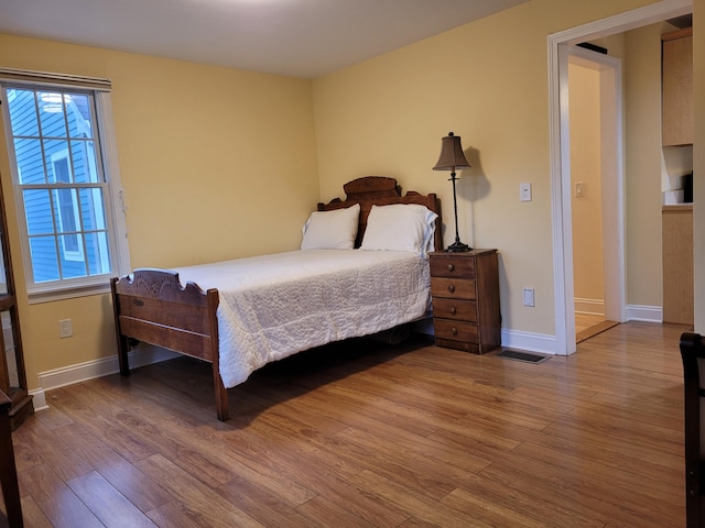 bedroom with wood-type flooring