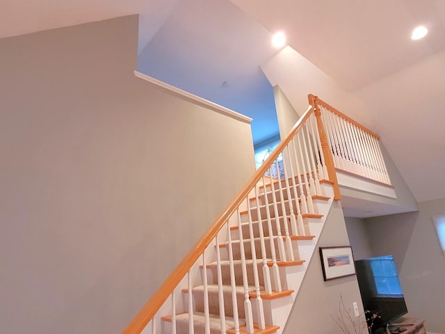 staircase featuring a towering ceiling