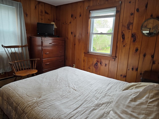 bedroom featuring wooden walls