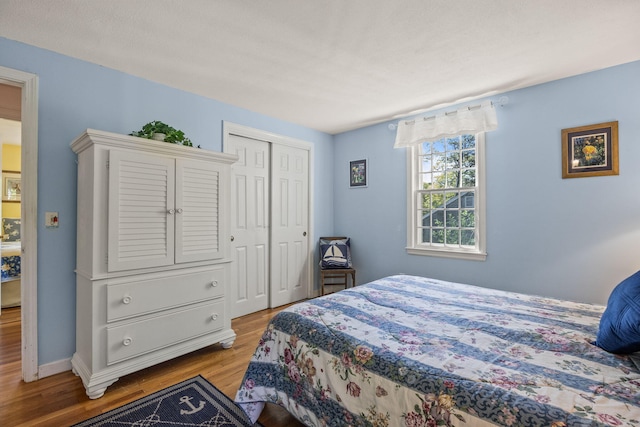 54 Mcnamara Ave, West Yarmouth, MA 02673 - bedroom with wood finished floors, a closet, and baseboards