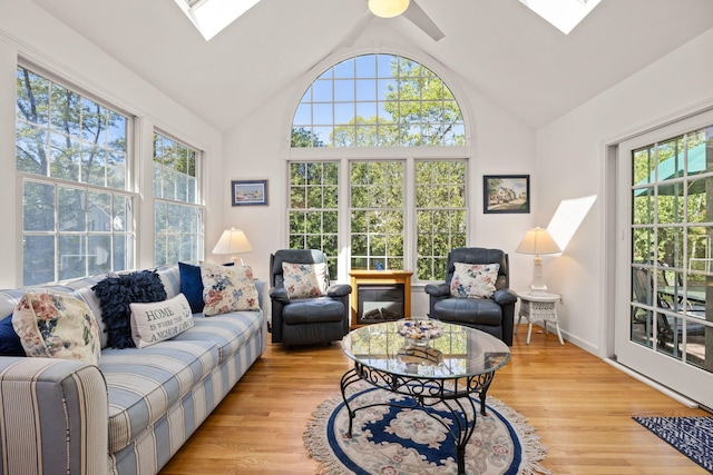54 Mcnamara Ave, West Yarmouth, MA 02673 - living room with a skylight, plenty of natural light, lofted ceiling, and light wood finished floors