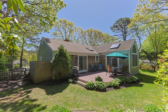 54 Mcnamara Ave, West Yarmouth, MA 02673 - rear view of house with a wooden deck, roof with shingles, and a chimney