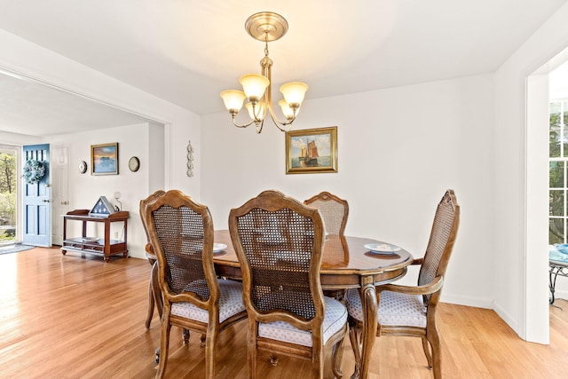 54 Mcnamara Ave, West Yarmouth, MA 02673 - dining room featuring a chandelier, light wood-style flooring, and baseboards