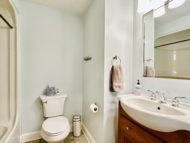 full bathroom with vanity, toilet, and baseboards