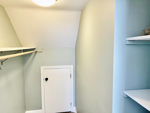 walk in closet featuring vaulted ceiling