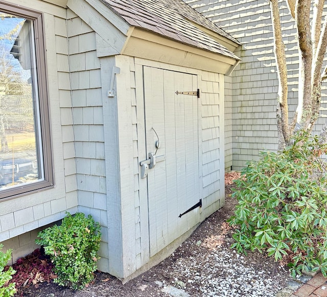 doorway to property featuring roof with shingles