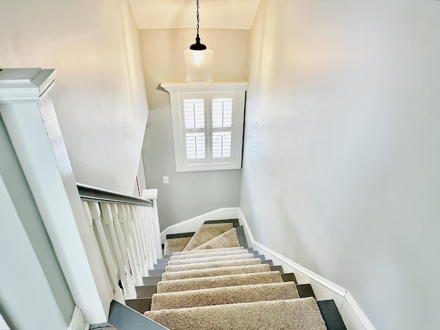 stairway featuring baseboards