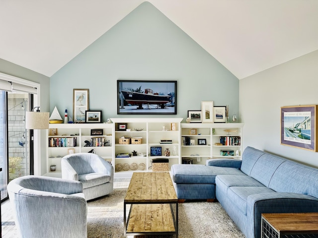 living area with high vaulted ceiling