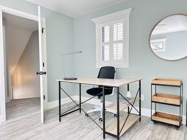 home office with wood finished floors and baseboards