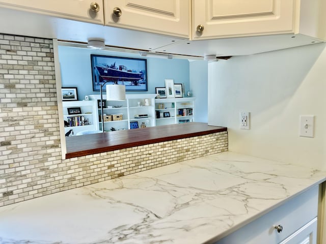 interior space with light stone counters and marble finish floor