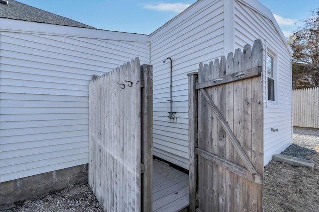 details featuring a shingled roof and fence