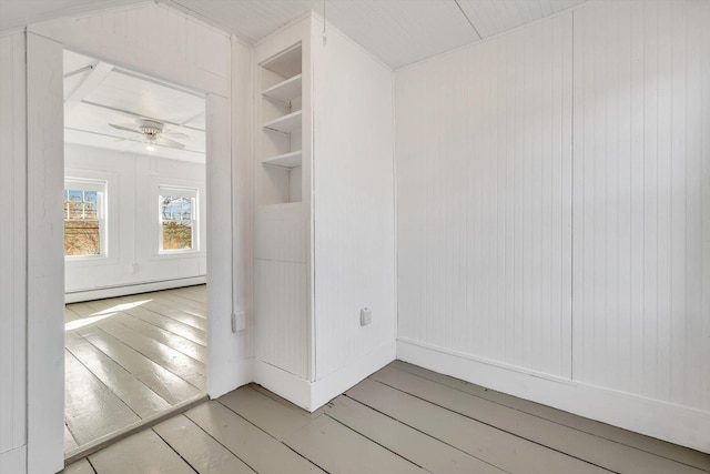 interior space featuring light wood finished floors, a baseboard radiator, and ceiling fan