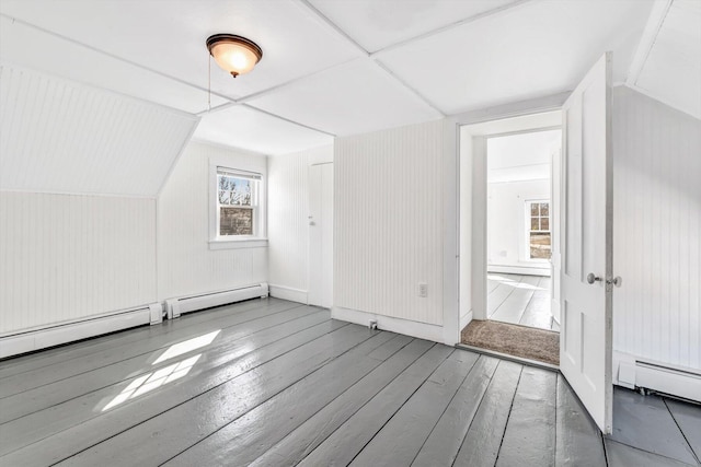 bonus room featuring a baseboard heating unit, a baseboard radiator, and hardwood / wood-style floors