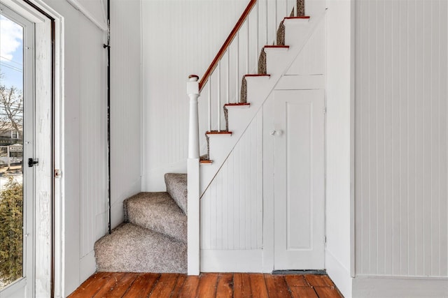 stairway featuring wood finished floors