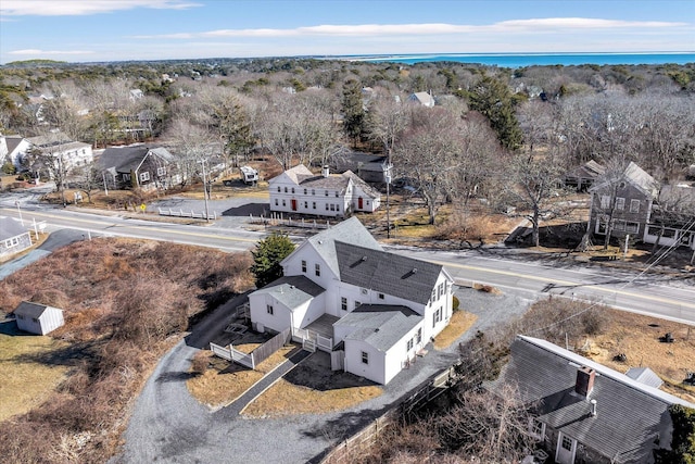 drone / aerial view featuring a water view and a residential view