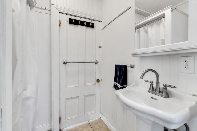 bathroom featuring tile patterned flooring and a sink